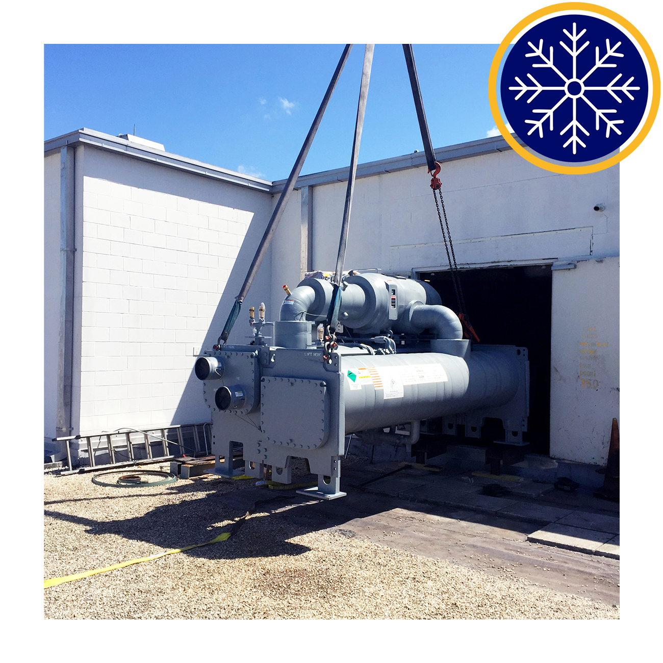 ndustrial chiller being lifted into a building with a snowflake icon in the corner.