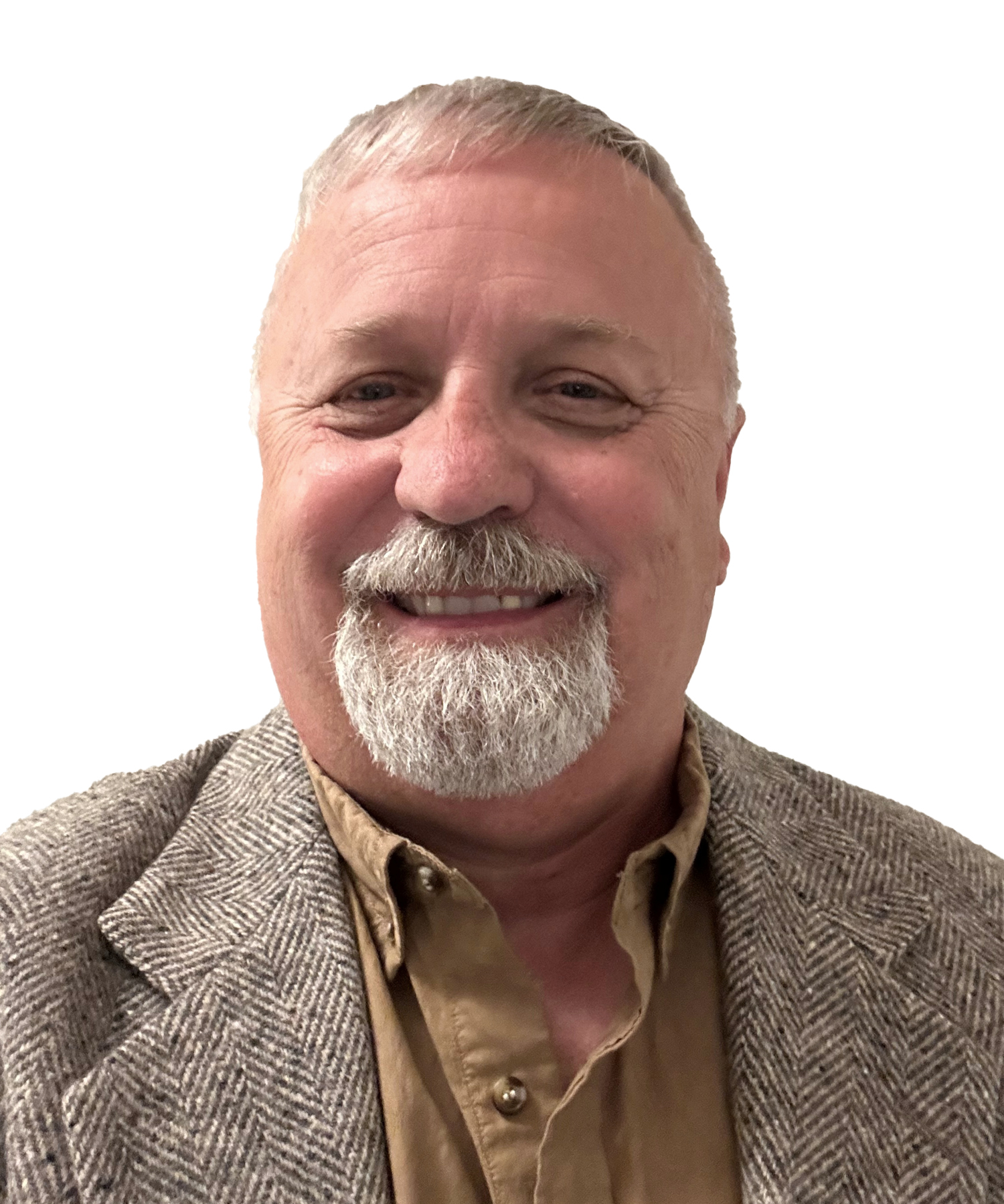 Smiling man with short gray hair and a white beard, wearing a tan button-up shirt and a gray herringbone blazer, in front of a white background.